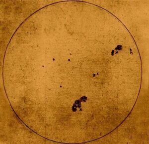 Galileo Galilei's hand-drawn sketch of the Sun, created by projecting the Sun's image through a telescope onto paper, showing several irregular, dark sunspots crossing the solar disk as he observed in the early 17th century.